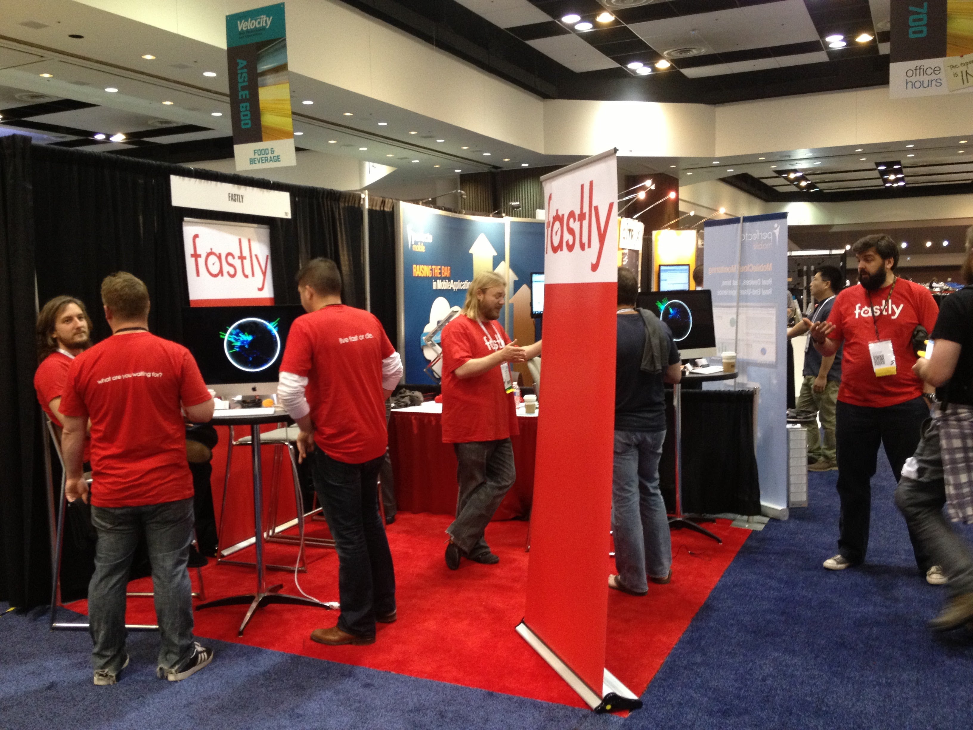 The Fastly team staffs a booth at Velocity conference.  